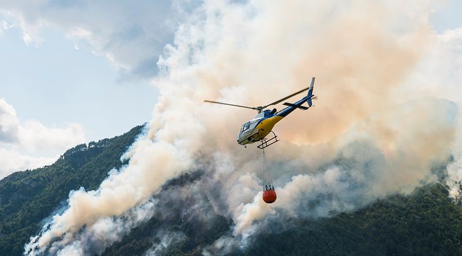 Aerial-Firefighting-with-helicopter-on-a-big-wildfire-in-a-pine-forest Aerial-Firefighting-with-helicopter-on-a-big-wildfire-in-a-pine-forest