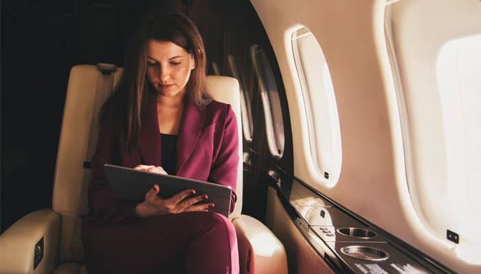 Business-Women-in-Private-Jet-Using-a-Tablet-That-is-Connected-to-Broadband-Internet-Using-SKYTRAC-Satcom-Services Business Women in Private Jet Using a Tablet That is Connected to Broadband Internet Using SKYTRAC Satcom Services