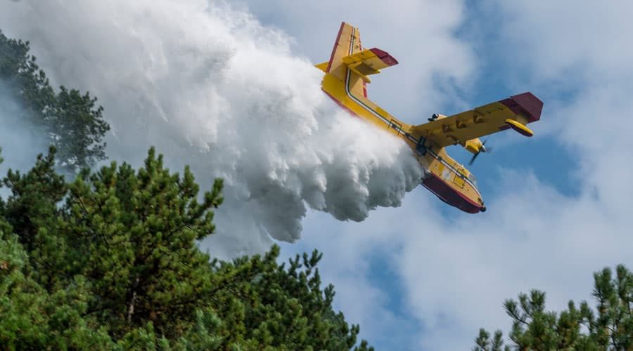 Yellow-Water-Bomber-Aircraft-Dropping-a-Large-Volume-of-Fire-Suppressant-on-Forest-Fire Yellow Water Bomber Aircraft Dropping a Large Volume of Fire Suppressant on Forest Fire