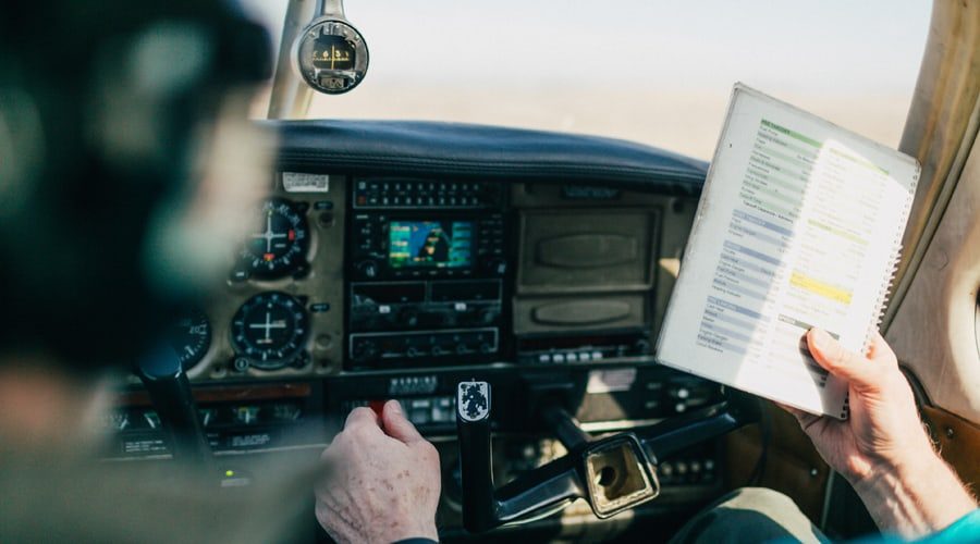 general-aviation-flight-school-instructor-teaching-student-with-preflight-checklist general-aviation-flight-school-instructor-teaching-student-with-preflight-checklist